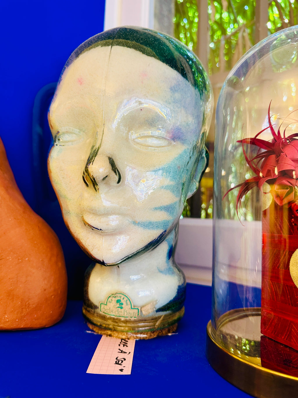 Tête en verre vintage "le verre à soi" contenant des sels de bain.